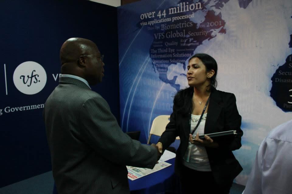 Two delegates shaking hands at an exhibition stand